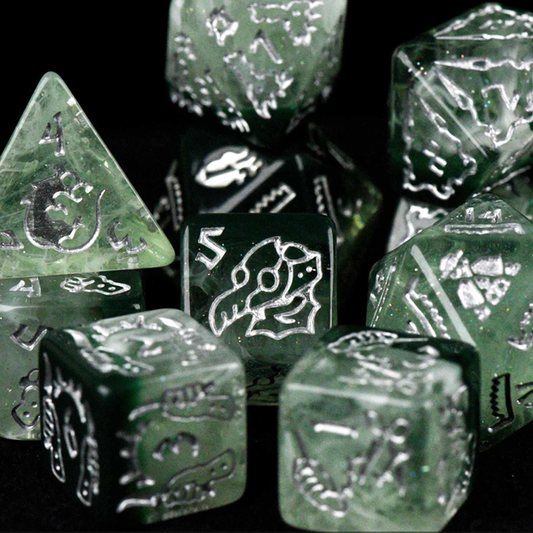 Set of green polyhedral dice with engraved symbols on a black background