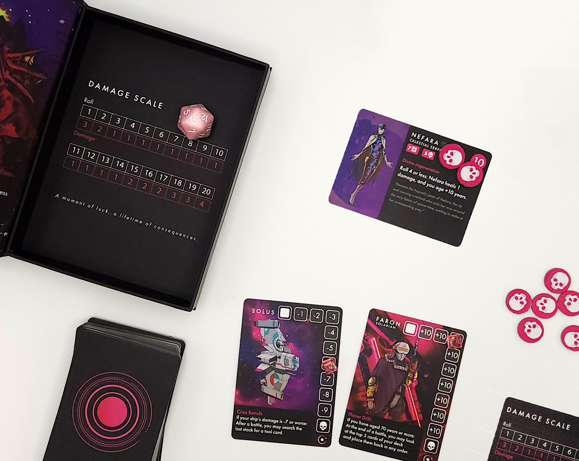 Solus Lost Card game components including cards and a damage scale on a white surface